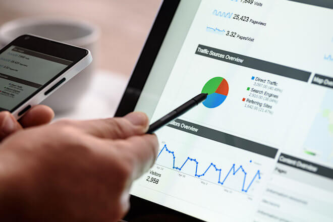 A photo showing a laptop monitor showing google analytics dashboard
